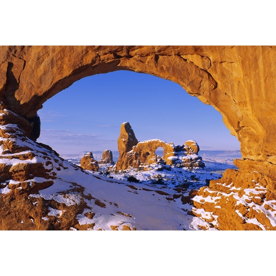 Morning light on North Window framing Turret Arch in winter Arches National Park Utah USA. Poster Print by Russ Bishop Image 1