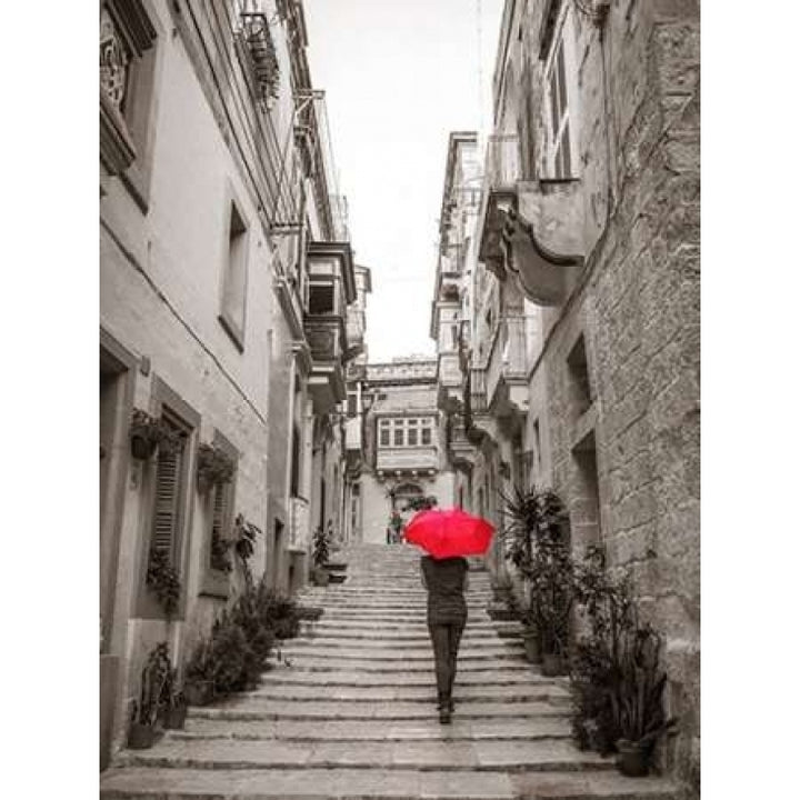 Tourist with umbrella in steps through houses in Birgu Malta Poster Print by Assaf Frank Image 1