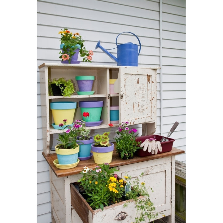 Potting bench with containers and flowers Marion County Illinois USA Poster Print Image 1