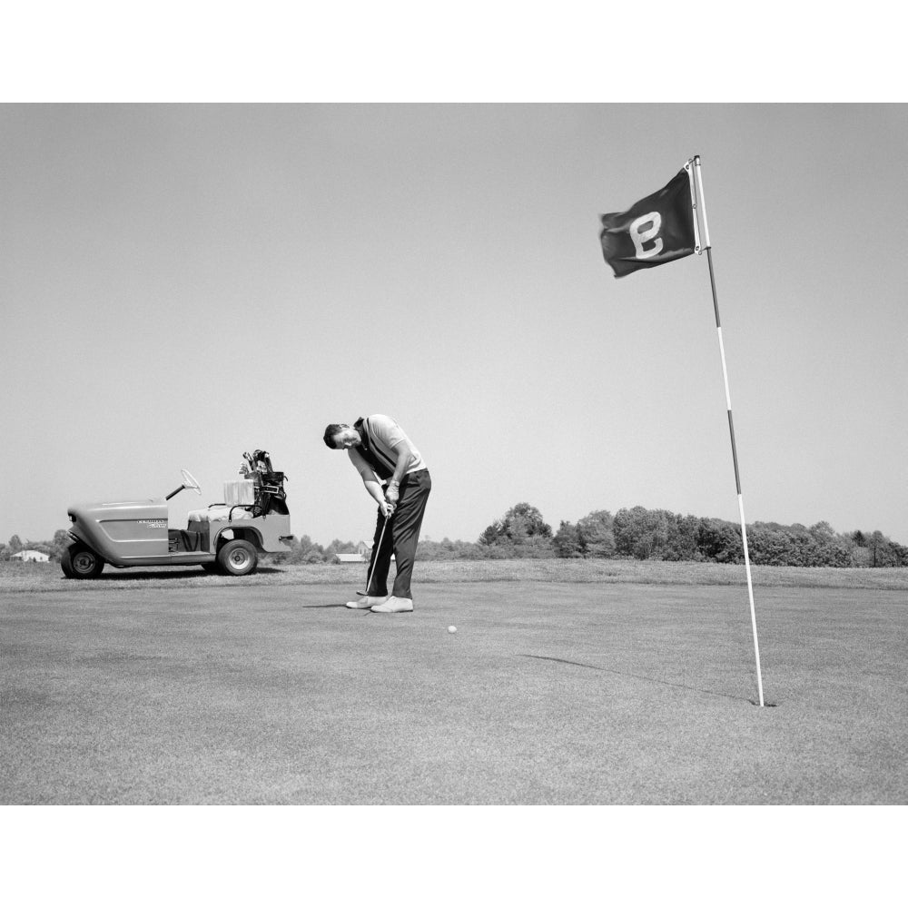 1960s Man Playing Golf Putting Golf Ball Towards Flag And Cup Hole On 9Th Green Spring Summer Outdoor Print By Vintage Image 1