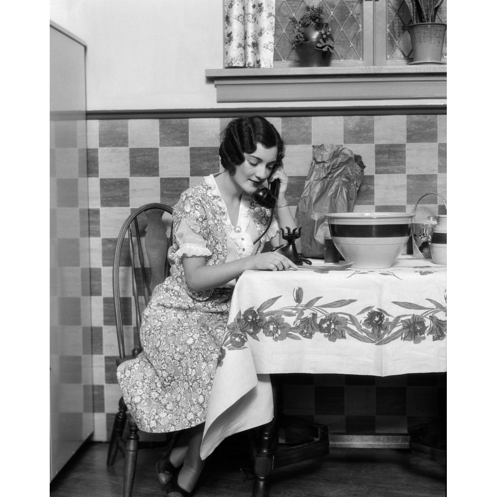 1920s Woman Sitting At Kitchen Table With Table Cloth While Smiling On Phone Print By Vintage Collection Image 1