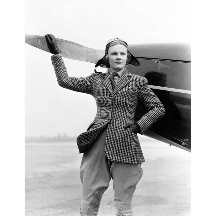 1930s Woman Aviator Pilot Standing Next To Airplane One Hand On Propeller Flight Goggles Cap Tweed Suit Fashion Print By Image 1