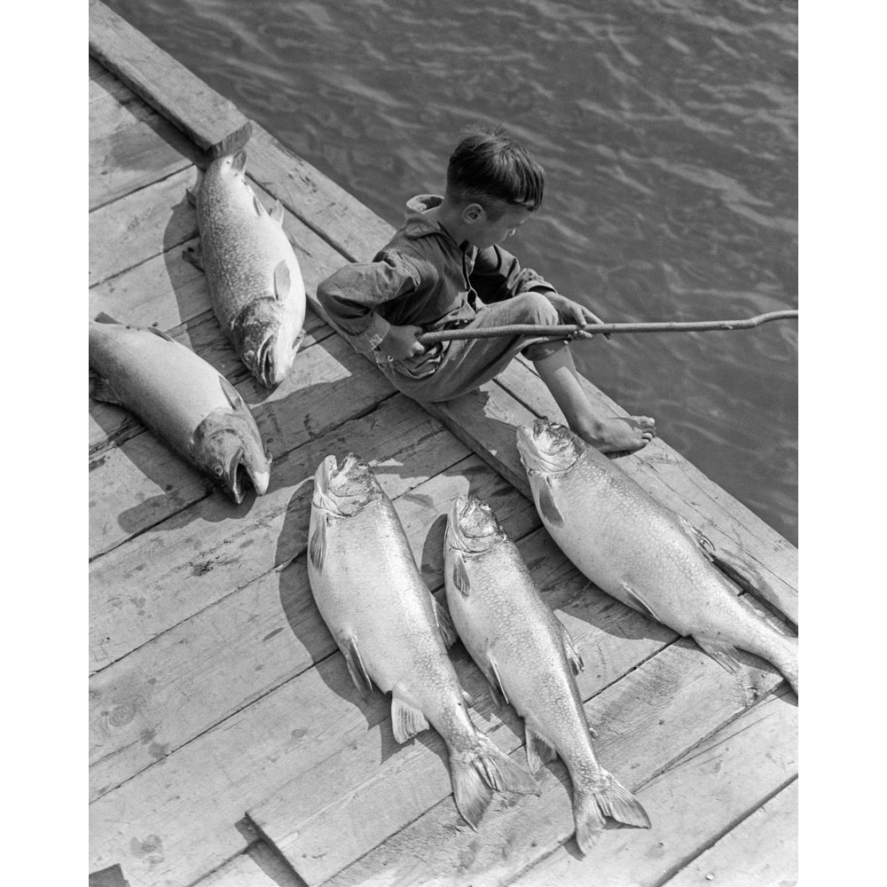 1930s Boy Seated On Dock With 5 Large Fish Fishing With Stick Pole Poster Print By Vintage Collection Image 1