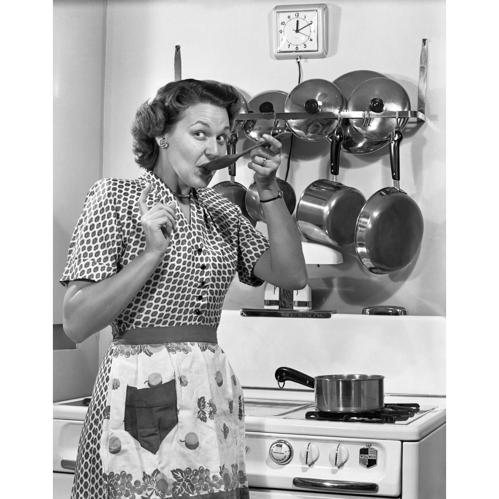 1950s Housewife Cooking Tasting Sauce With Spoon By Stove Funny Facial Expression Looking At Camera Print By Vintage Image 1