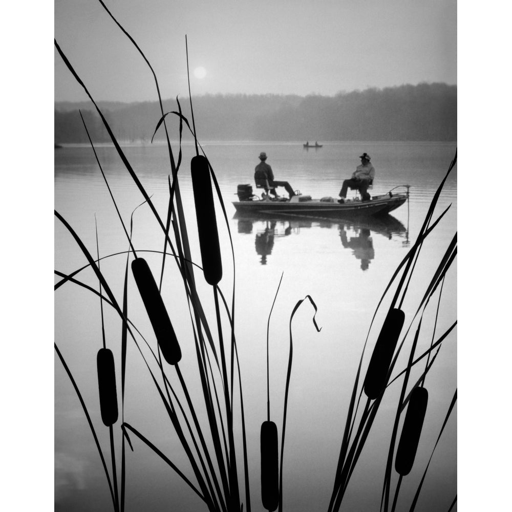 1980s Two Silhouetted Men In Bass Fishing Boat On Calm Water Lake Cattails In Foreground Print By Vintage Collection Image 1