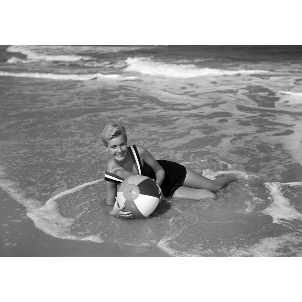 1960s Woman In Bathing Suit Lying In The Surf Holding A Beach Ball Smiling Outdoor Print By Vintage Collection Image 1