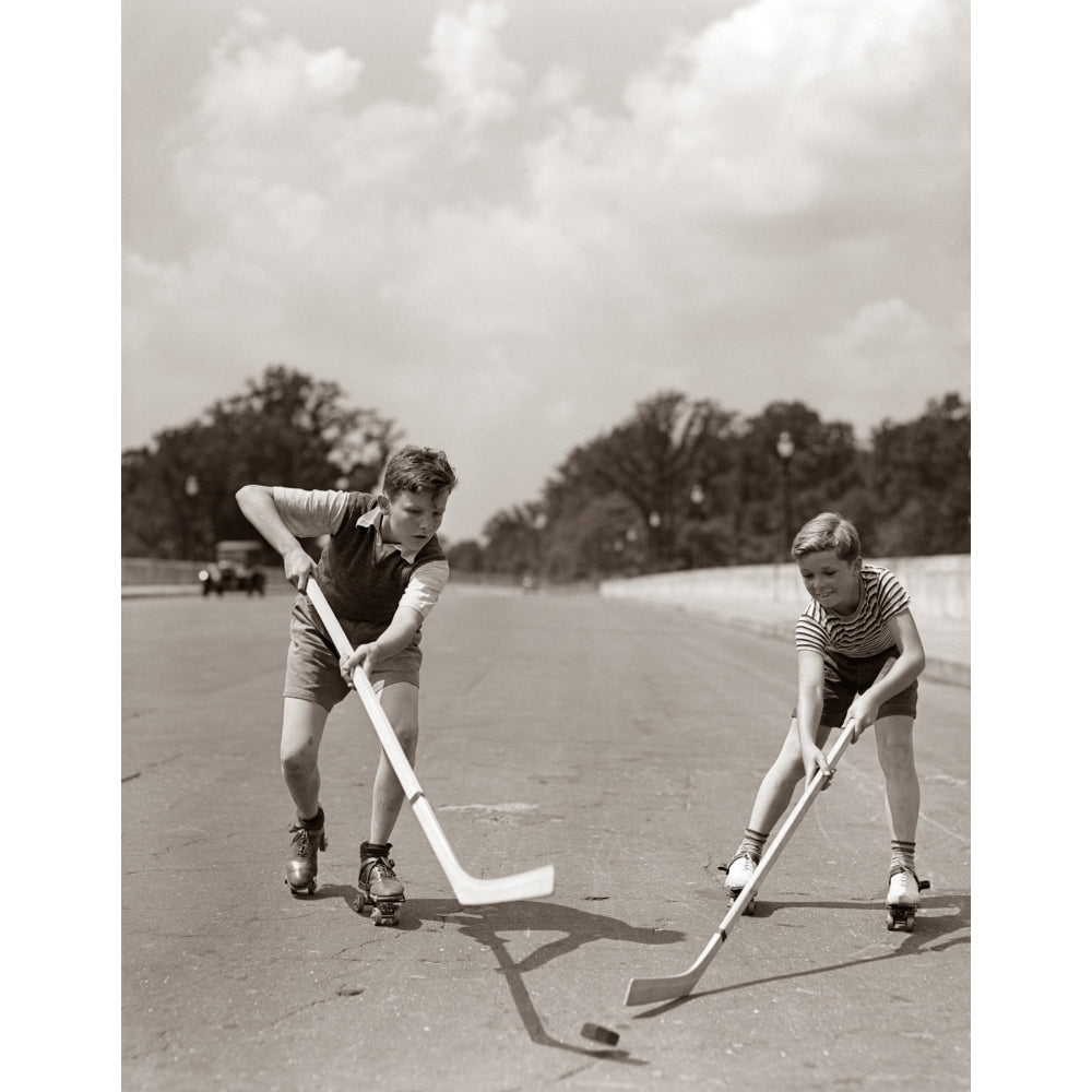 1930s-1940s 2 Boys With Sticks And Puck Wearing Roller Skates Playing Street Hockey Print By Vintage Collection Image 1