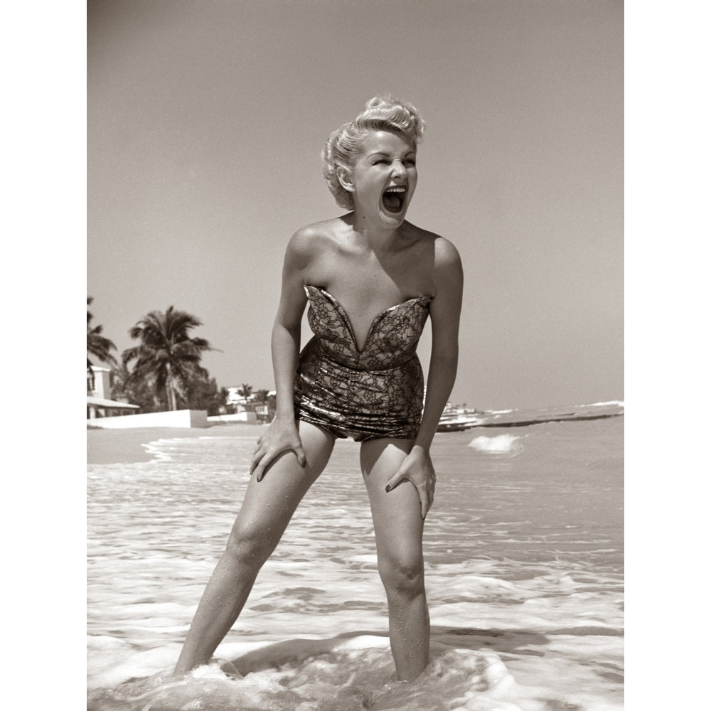 1950s Laughing Blonde Woman In Strapless Low Cut Bathing Suit Swim Wear Wading Up To Ankles In Surf Print By Vintage Image 1