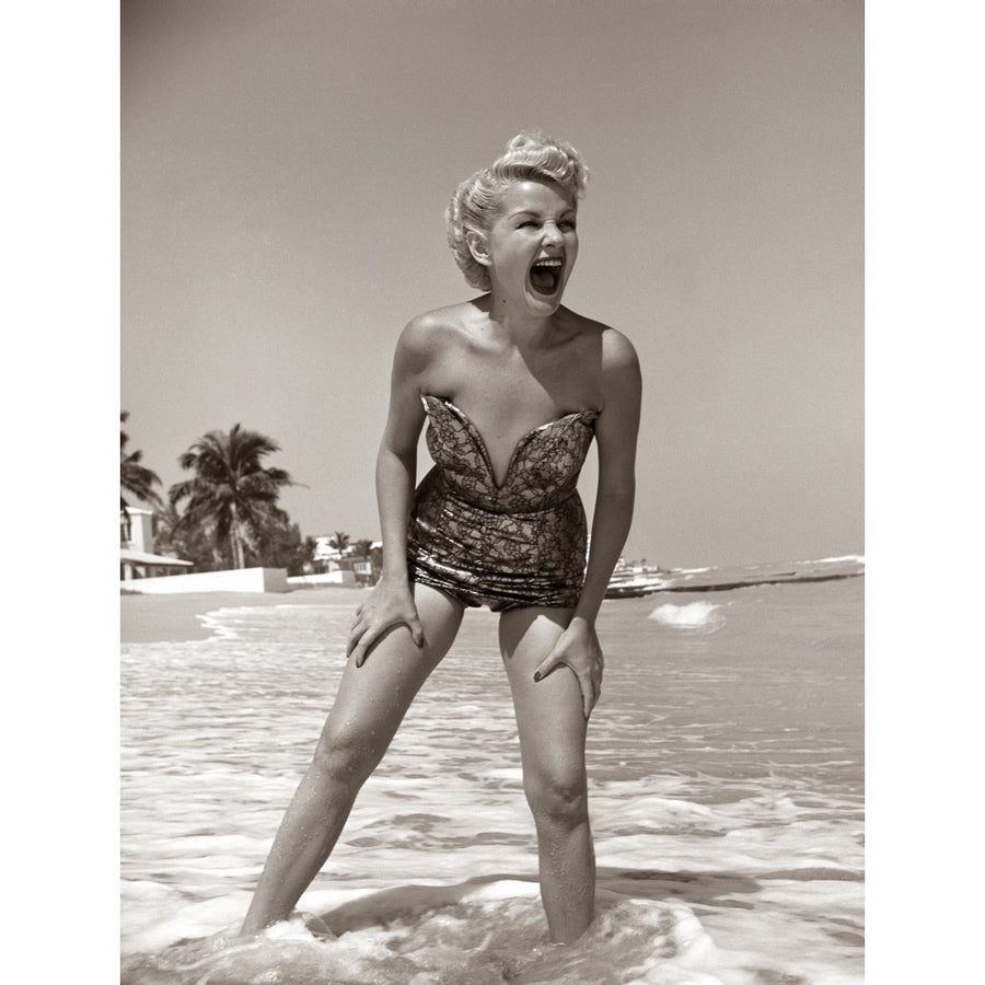 1950s Laughing Blonde Woman In Strapless Low Cut Bathing Suit Swim Wear Wading Up To Ankles In Surf Print By Vintage Image 1