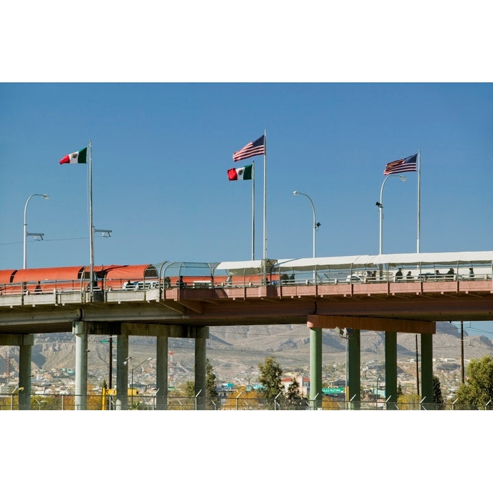 International border of Mexico and the United States with flags and walking bridge connecting El Paso Texas to Juarez Image 1