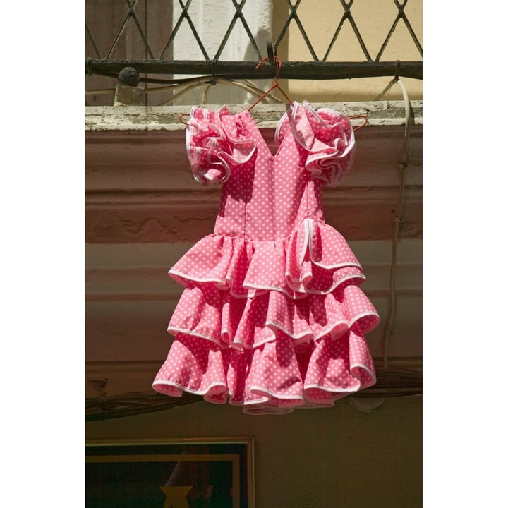 Pink flamenco dress for little girl hangs in Centro old district of Sevilla Spain Print by Panoramic Images Image 2