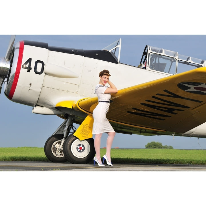 1940s style Navy pin-up girl leaning on the wing of a T-6 Texan Poster Print Image 1