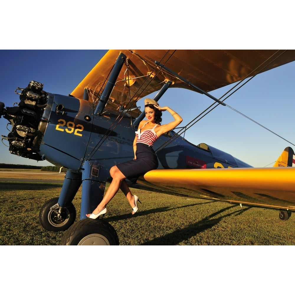 1940s style pin-up girl sitting on the wing of a Stearman biplane Poster Print Image 2