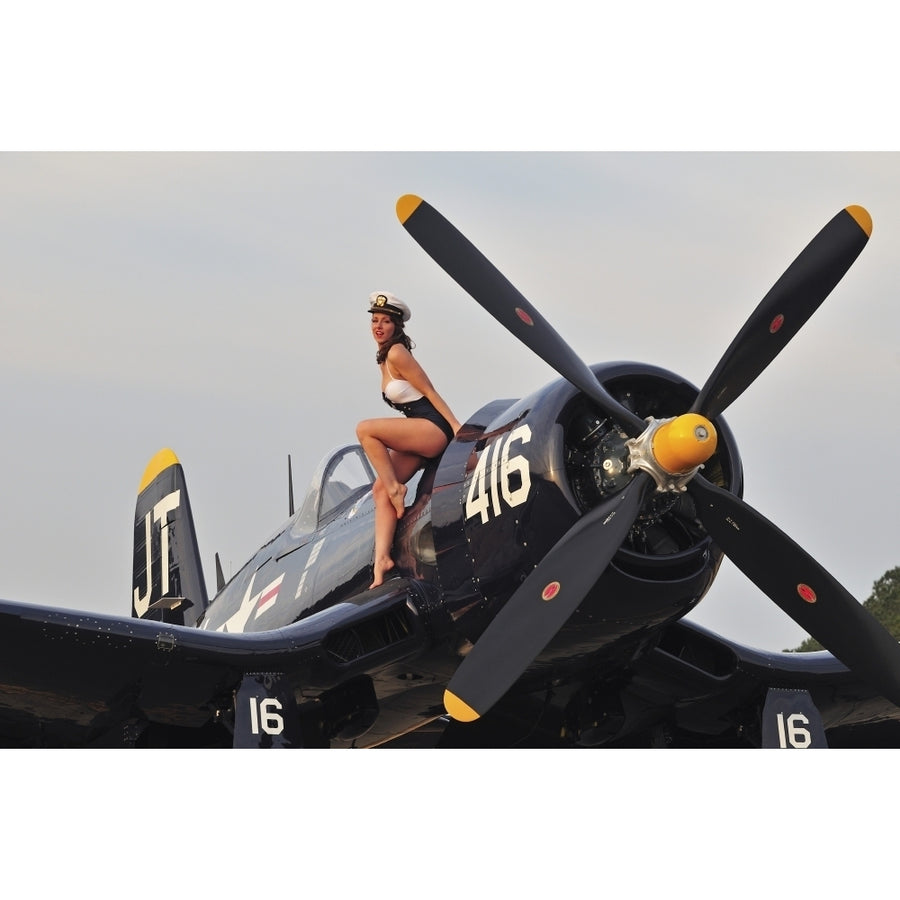 1940s style Navy pin-up girl sitting on a vintage Corsair fighter plane Poster Print Image 1