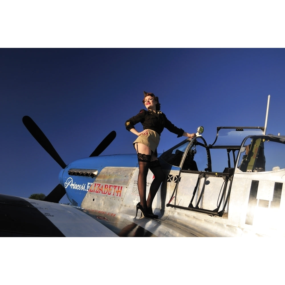 Pin-up girl standing on the wing of a P-51 Mustang Poster Print Image 1