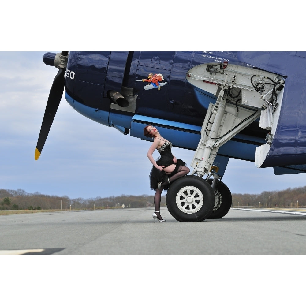 1940s style pin-up girl in cocktail dress posing in front of a TBM Avenger Poster Print Image 1