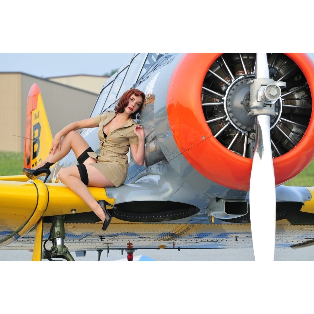 1940s style pin-up girl posing on a T-6 Texan training aircraft Poster Print Image 2