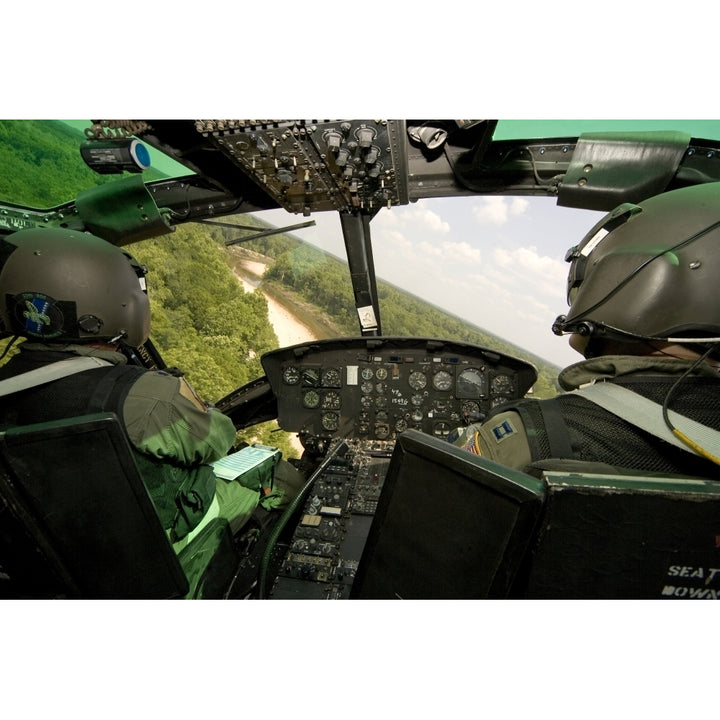 Two instructor pilots practice low flying operations in a UH-1H Huey helicopter Poster Print Image 2