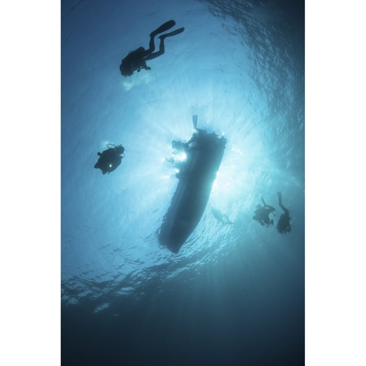 Scuba divers descend from their dive boat Poster Print Image 1