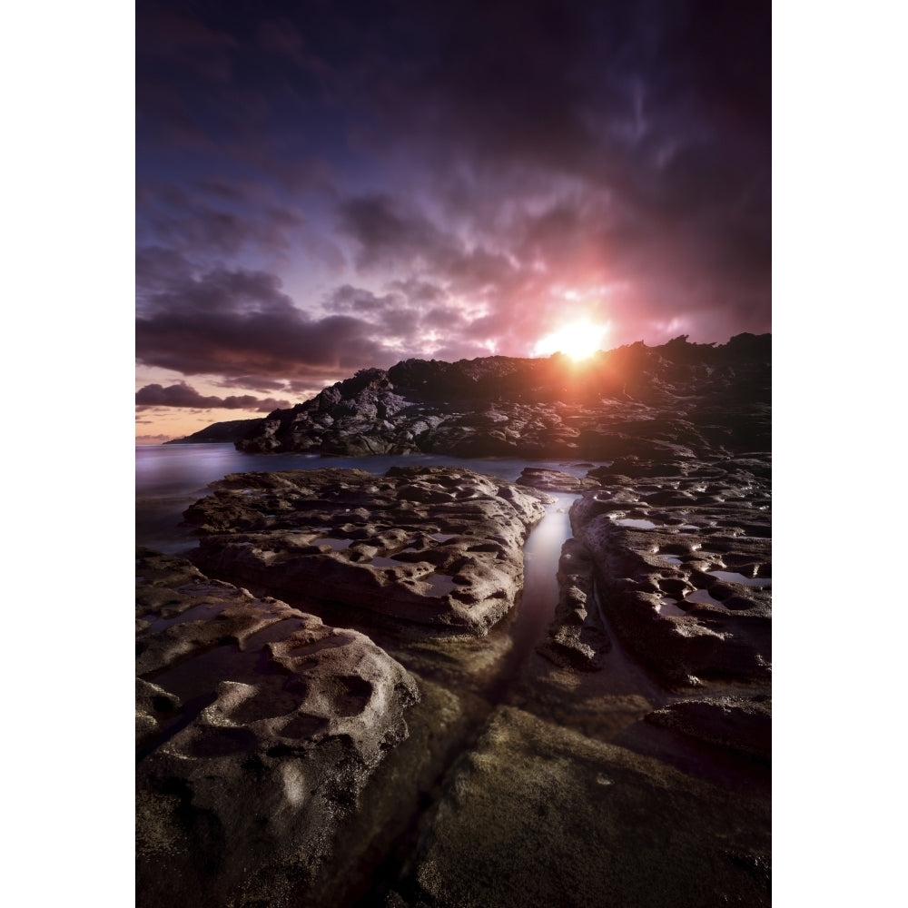 Rocky shore and tranquil sea against cloudy sky at sunset Sardinia Italy Poster Print Image 2