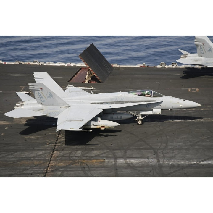 An F/A-18C Hornet sits ready on the flight deck of USS Harry S. Truman Poster Print Image 1