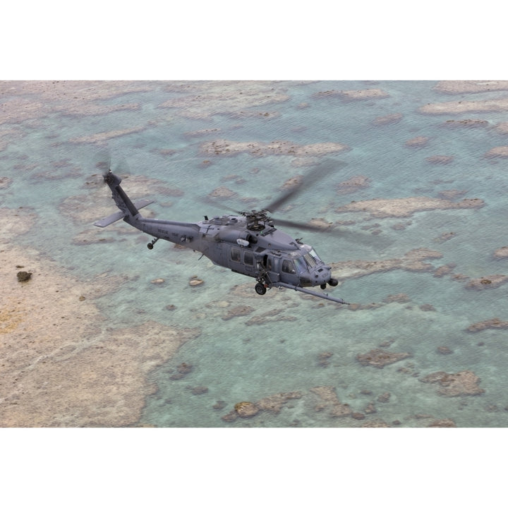 An HH-60G Pave Hawk flies along the coastline of Okinawa Japan Poster Print Image 1