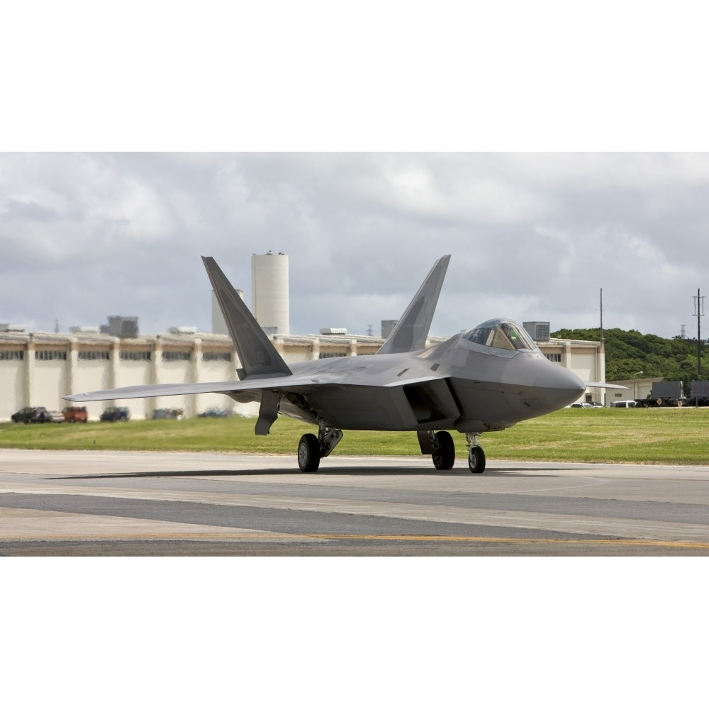 An F-22 Raptor taxis to the end of runway at Kadena Air Base Japan Poster Print Image 1