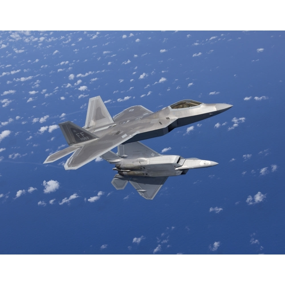 Two F-22 Raptors maneuver while flying a training mission over Japan Poster Print Image 2