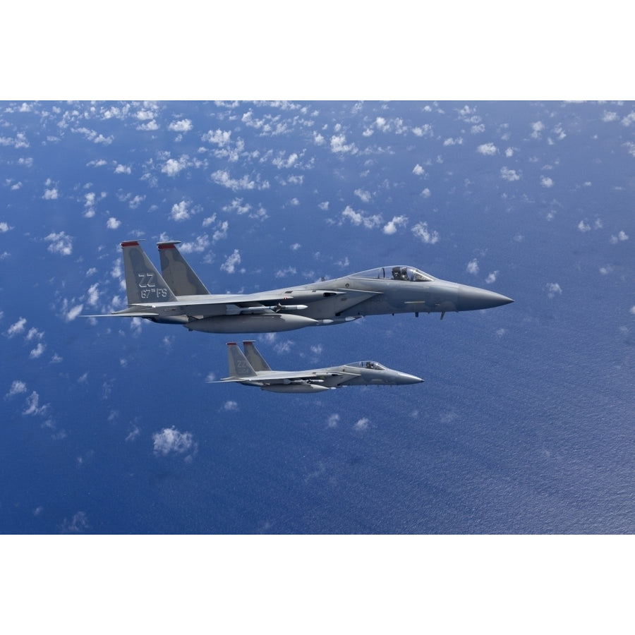 Two F-15 Eagles flies over the Pacific Ocean during a training mission Poster Print Image 1