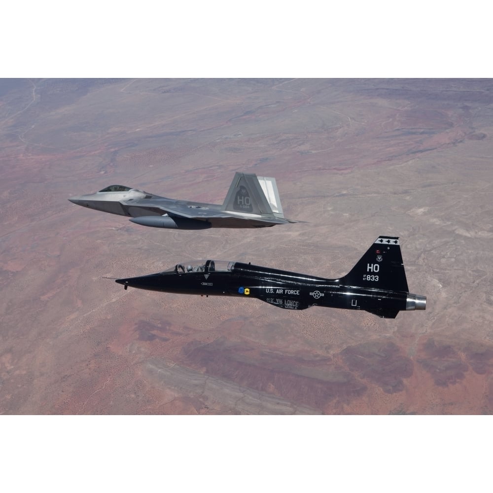 An F-22 Raptor and a T-38 Talon fly in formation over Mexico Poster Print Image 1