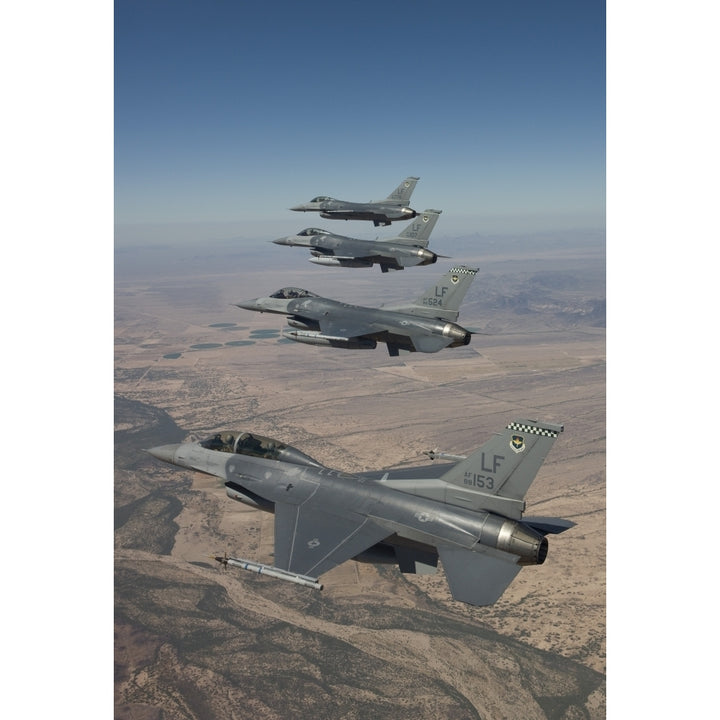 Four F-16s maneuver on a training mission over the Arizona desert Poster Print Image 2