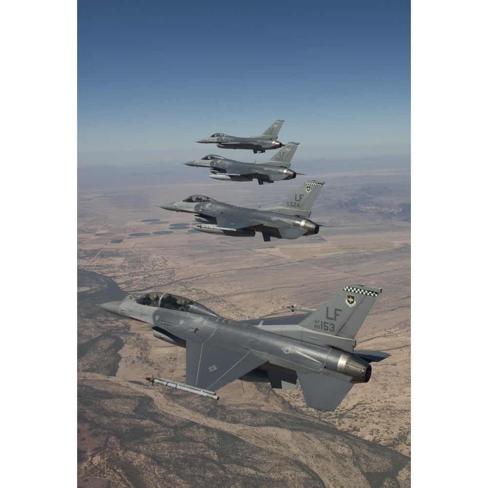 Four F-16s maneuver on a training mission over the Arizona desert Poster Print Image 1