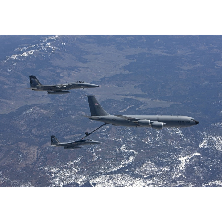 Two F-15 Eagles conduct aerial refueling with a KC-135 Stratotanker Poster Print Image 1