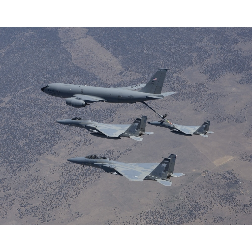 Three F-15 Eagles conduct aerial refueling with a KC-135 Stratotanker Poster Print Image 2