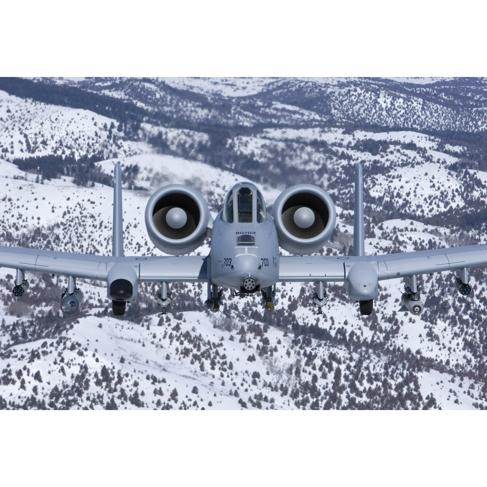 An A-10C Thunderbolt flies over the snowy Idaho countryside Poster Print Image 1