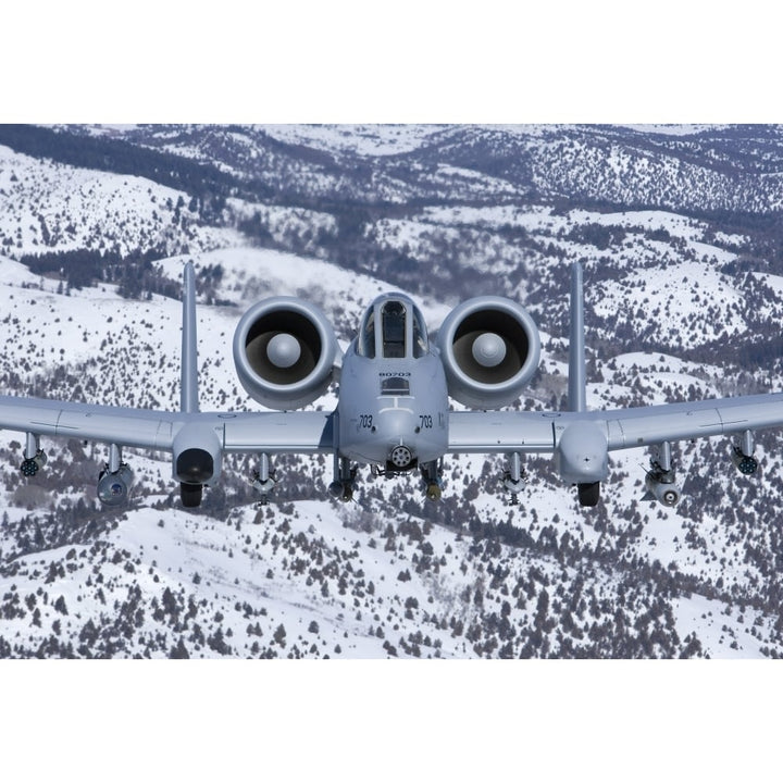 An A-10C Thunderbolt flies over the snowy Idaho countryside Poster Print Image 1