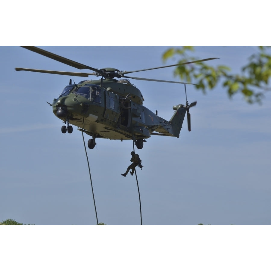 A pathfinder of the Belgian Army fast-roping from a NH90 helicopter Poster Print Image 1