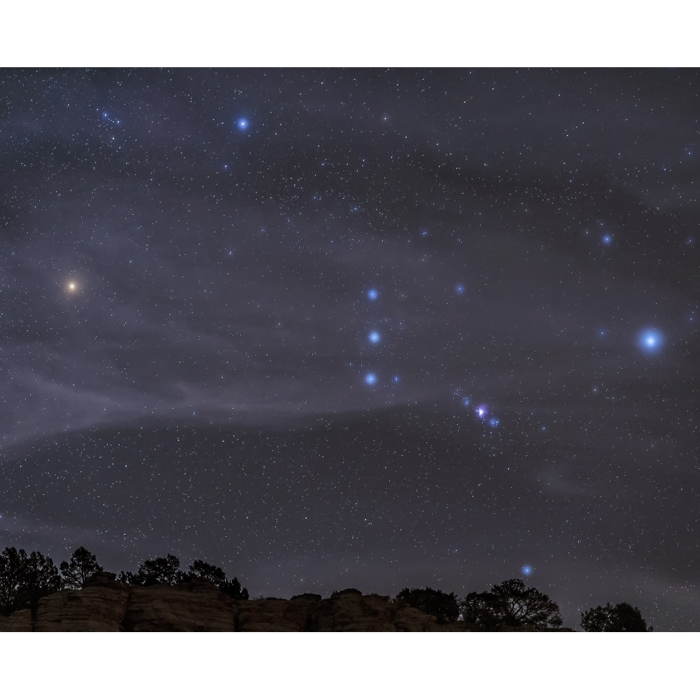 The Orion constellation rises over a hill through high thin clouds Poster Print Image 1