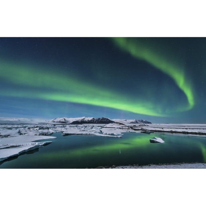 The northern lights dance over the glacier lagoon in Iceland Poster Print Image 1