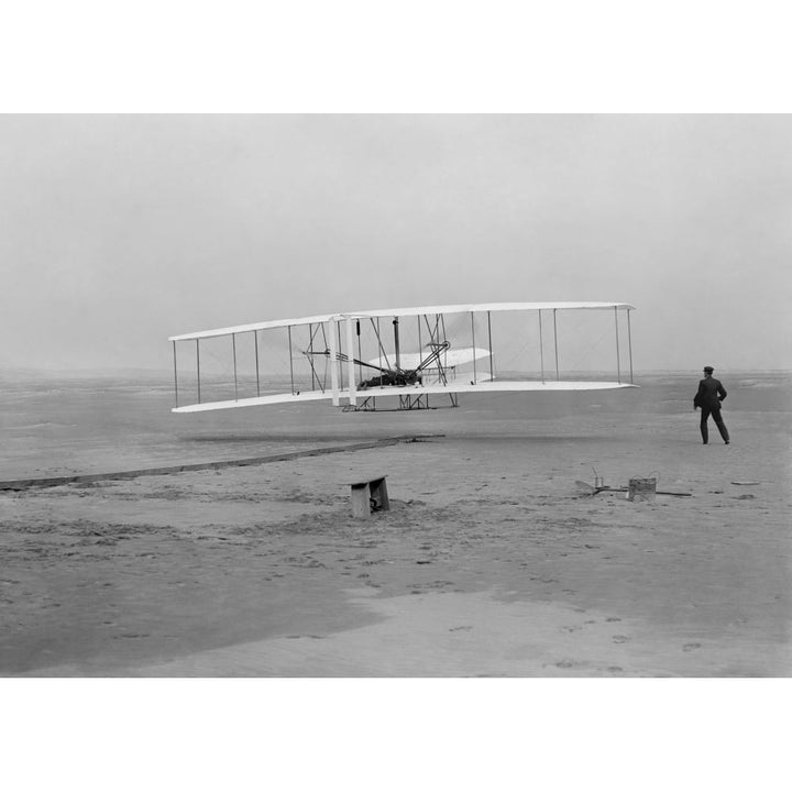 The first flight of the Wright Flyer in 1903 Poster Print Image 1