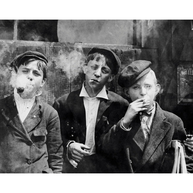 Missouri newsboys smoking on a street in St Louis 1910 Poster Print by John Parrot/Stocktrek Images Image 1