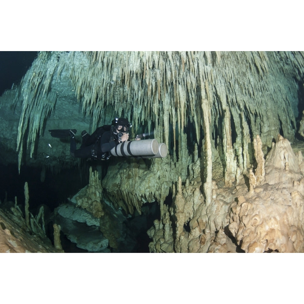 Diver using side mount gear in cave in Mexico Poster Print Image 1