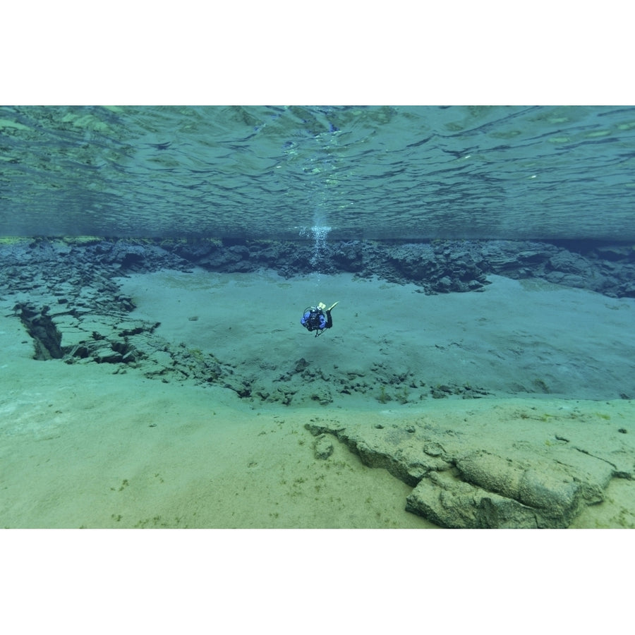 Diver in ultra clear water at The Silfra Lagoon Iceland Poster Print Image 1