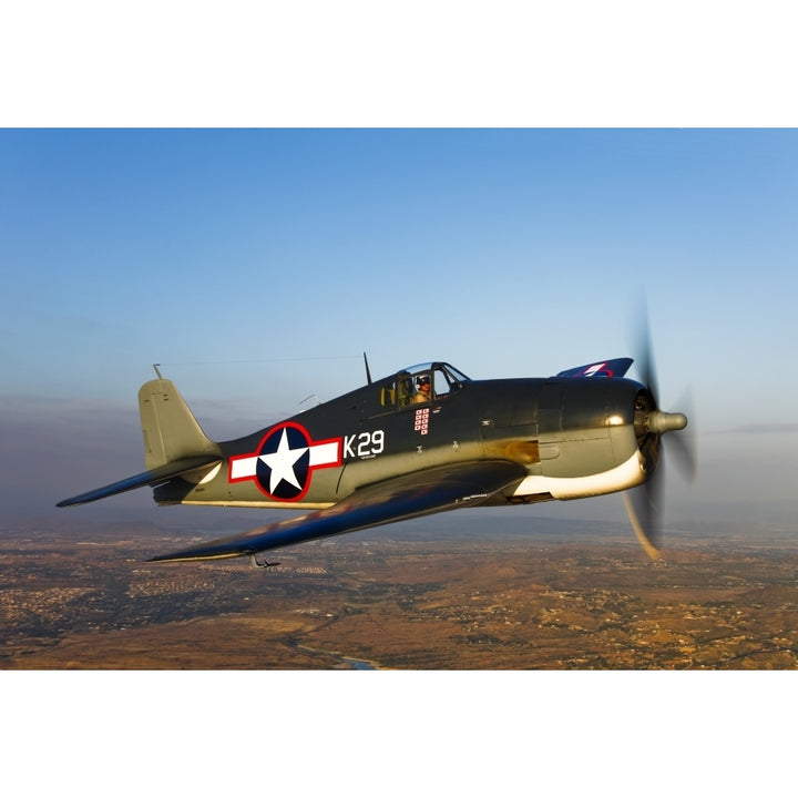 A Grumman F6F Hellcat fighter plane in flight Poster Print Image 1