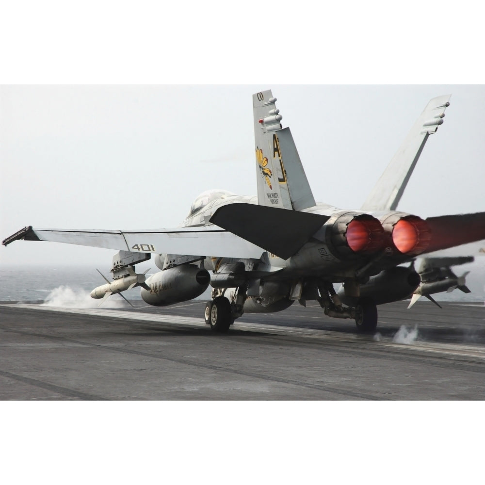 An F/A-18C Hornet launches from the flight deck of USS Theodore Roosevelt Poster Print Image 1