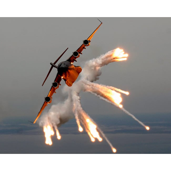 A C-17 Globemaster III releases flares over the Atlantic Ocean Poster Print by Stocktrek Images Image 2