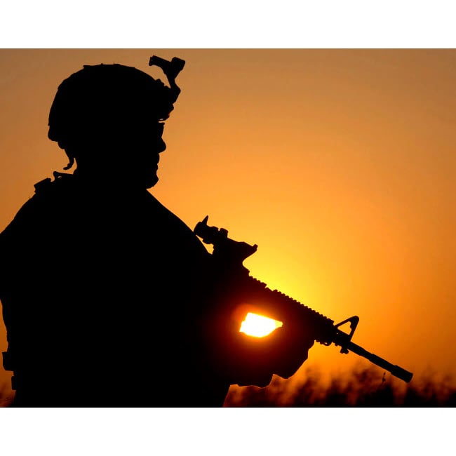 Silhouette of a US Army Soldier providing perimeter security Poster Print by Stocktrek Images Image 1