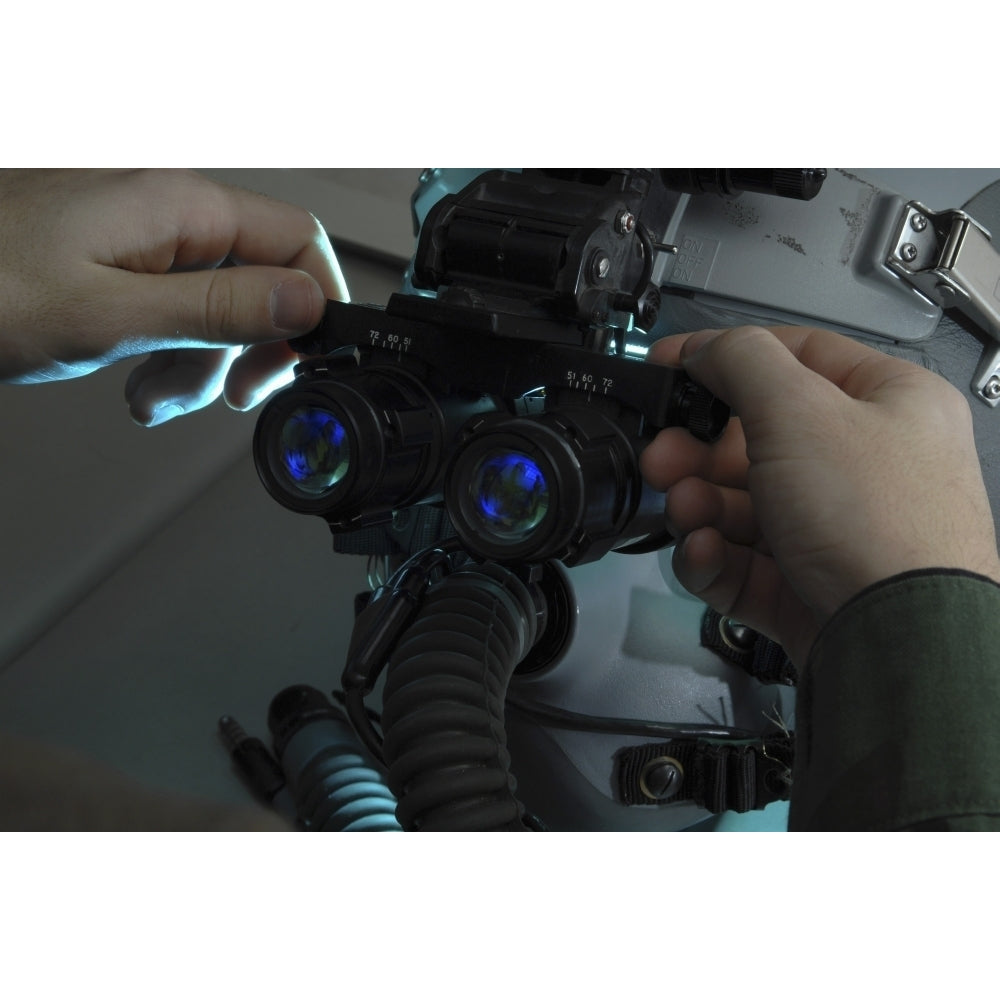 Airman adjusts the eyespan on a pair of night vision goggles Poster Print Image 1