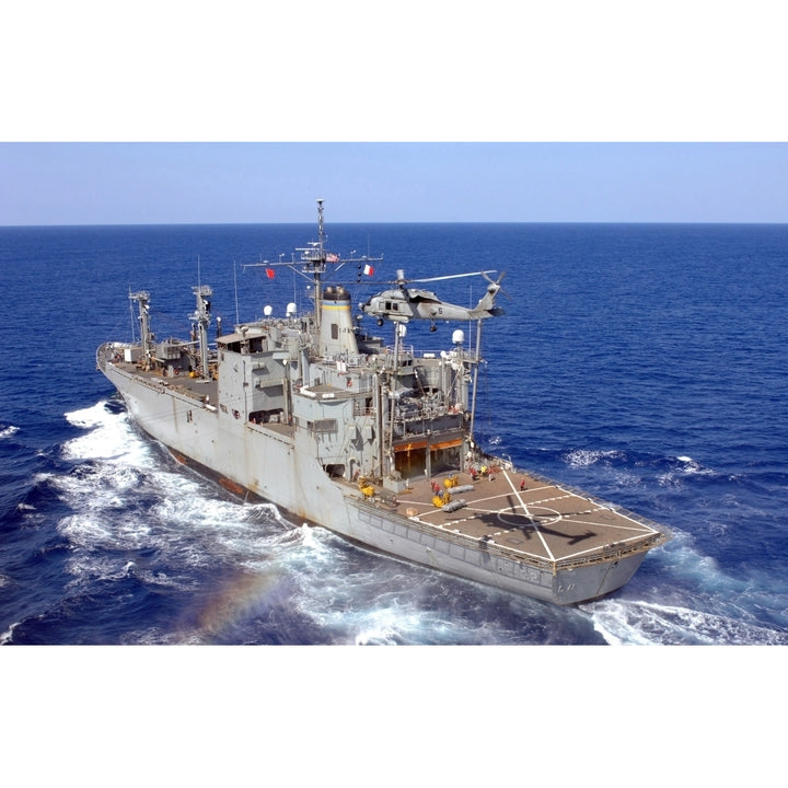 A helicopter clears the flight deck of the Military Sealift Command ammunition ship USNS Flint Poster Print Image 1