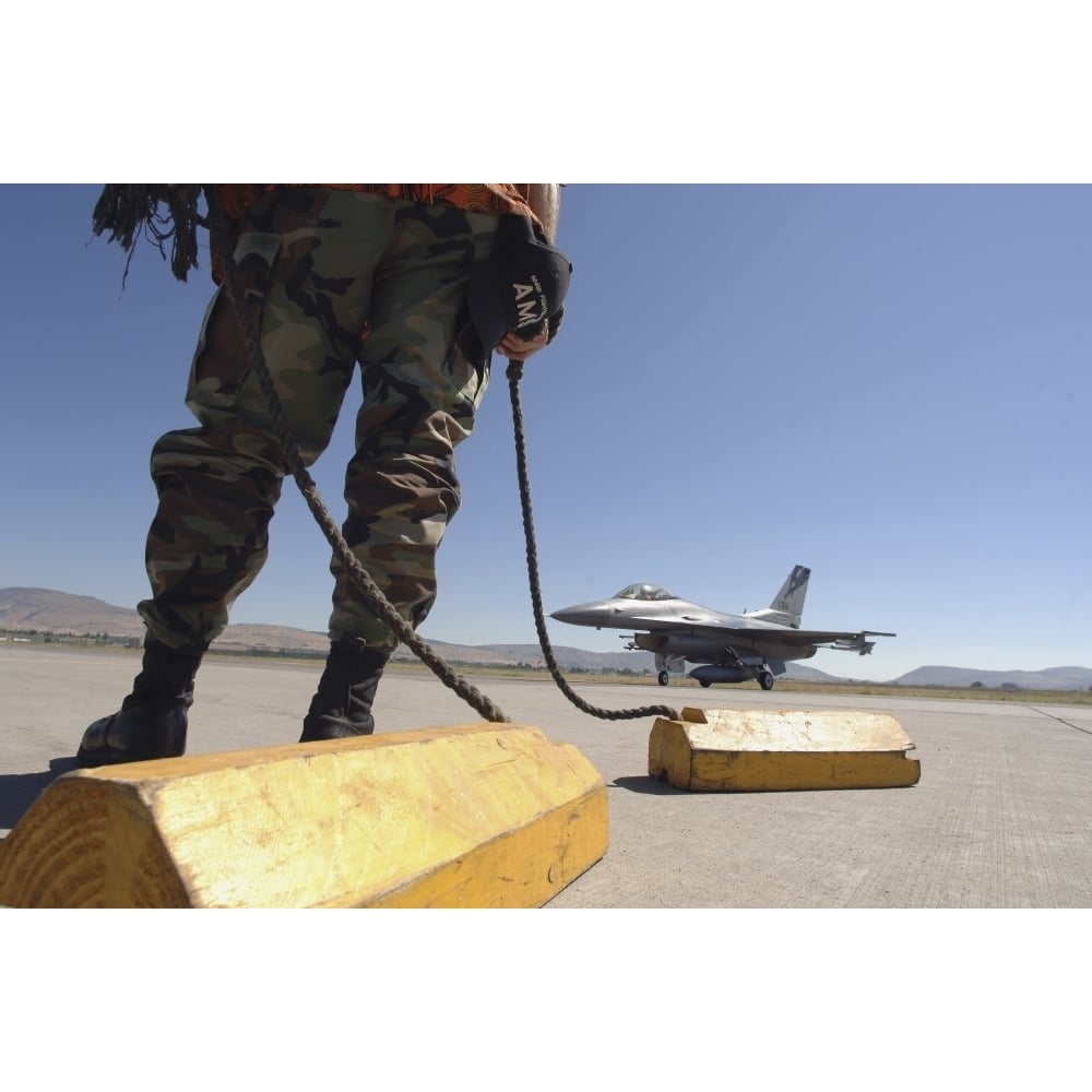 A U.S. Air Force crew chief waits to chalk the flight of an aircraft Poster Print Image 1